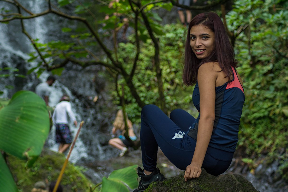 Me sitting on a rock in fronyt of Oahu waterfall